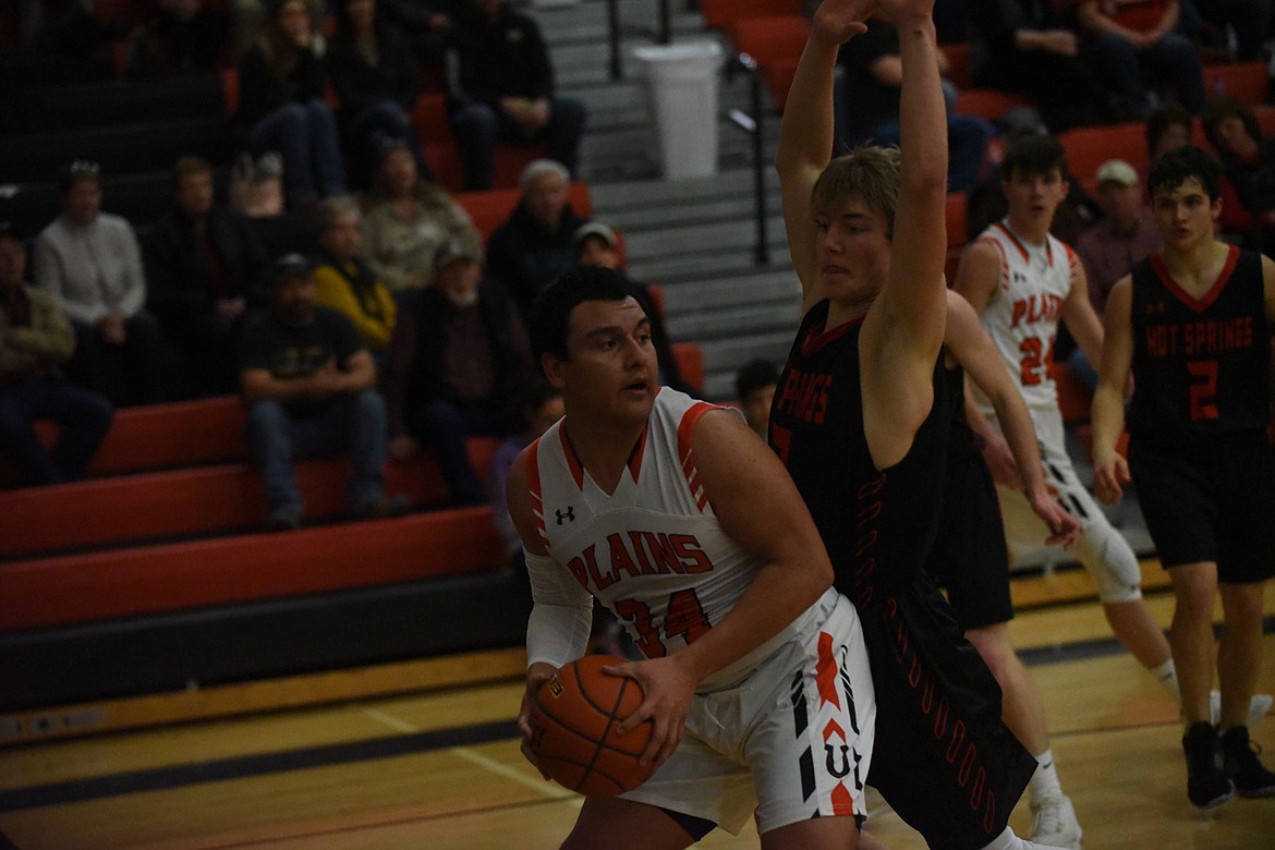 Plains&#146; Esvin Reyes goes against Hot Springs&#146; Jack McAllister during Friday&#146;s game at the 14-C District tournament in Ronan. (Scott Shindledecker/Valley Press)