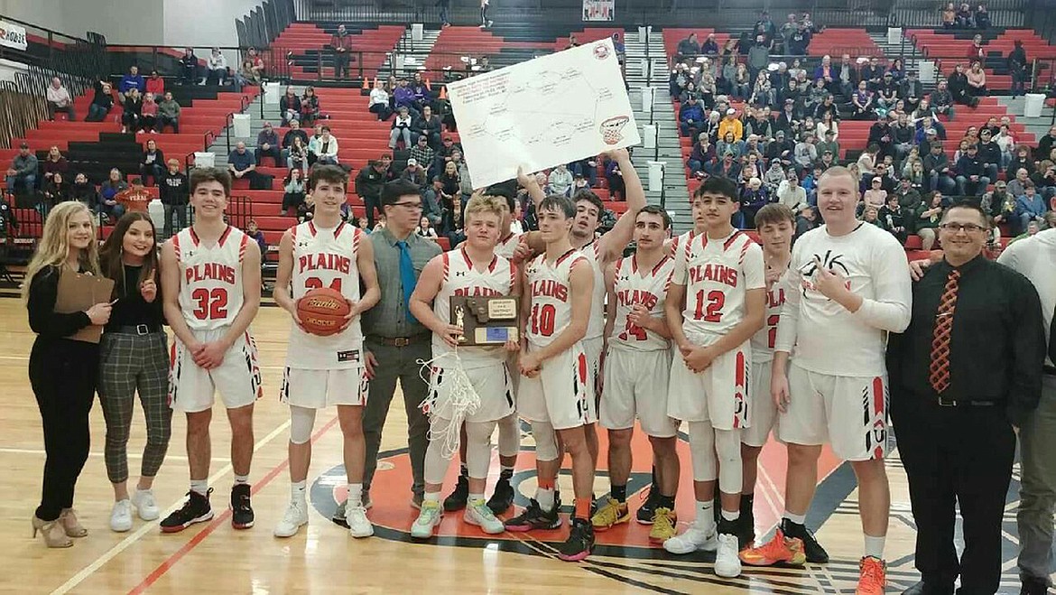 The Plains Horsemen celebrate winning the 14-C District tournament Saturday night in Ronan. (Chuck Bandel/Valley Press)