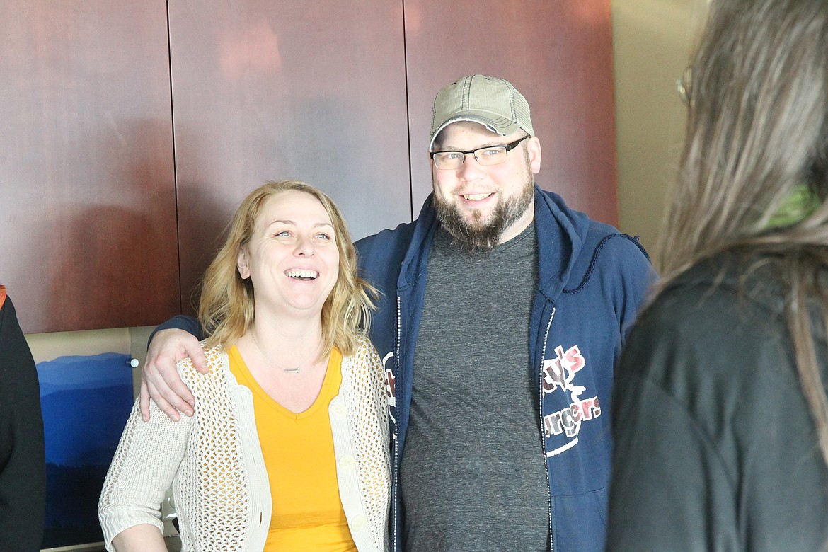 BILL BULEY/Press
Schmidty&#146;s Burgers owners Nathan and Denise Schmidt enjoy a light moment at Wednesday presentation of funds from Saturday&#146;s concert by The Rub for the Jan. 20 fire victims in downtown Coeur d&#146;Alene.