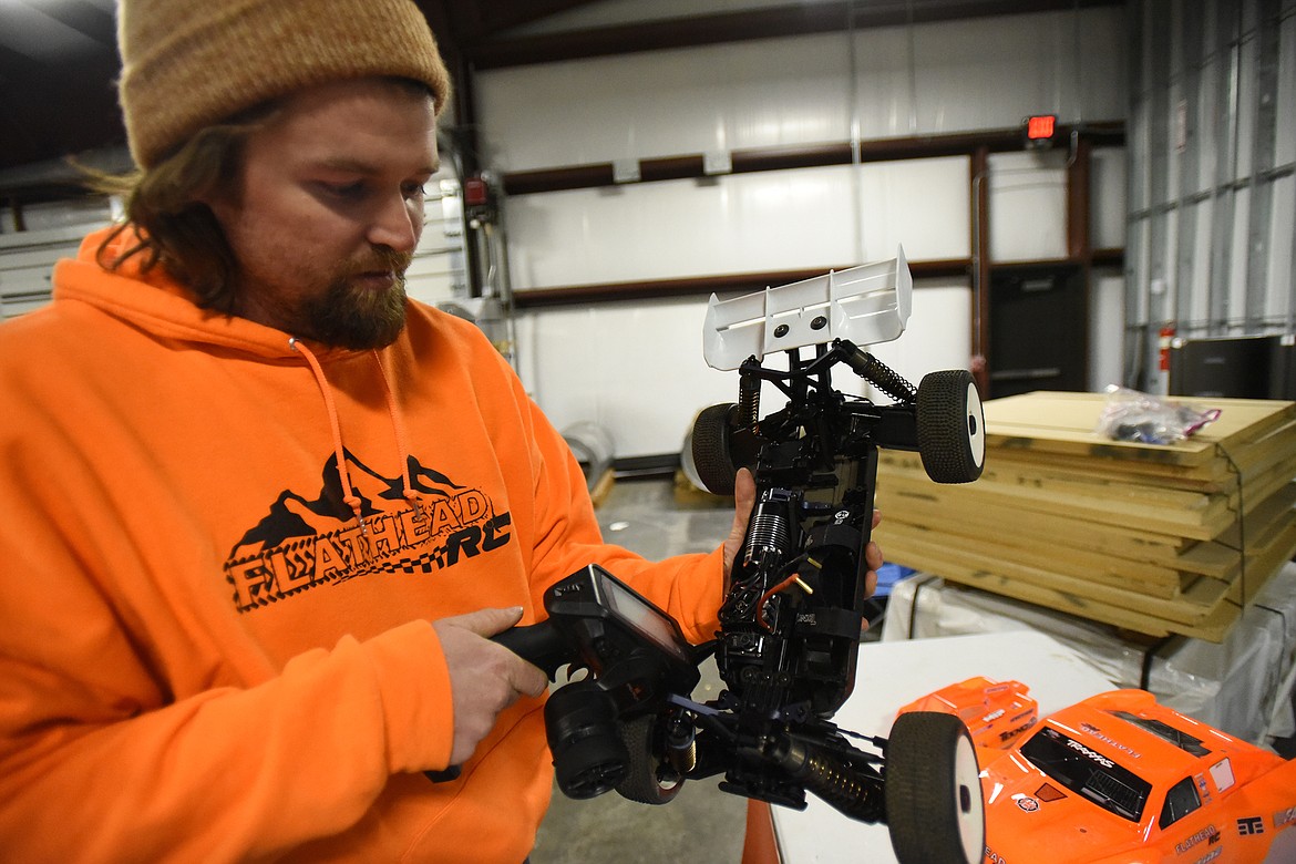 Flathead RC founder Angus Matheson shows off the interior workings of one of his vehicles.