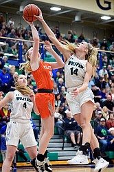 Glacier's Aubrie Rademacher (14) blocks the shot of Flathead's Maddy Moy (5) during a crosstown matchup at Glacier High School on Friday. (Casey Kreider/Daily Inter Lake)