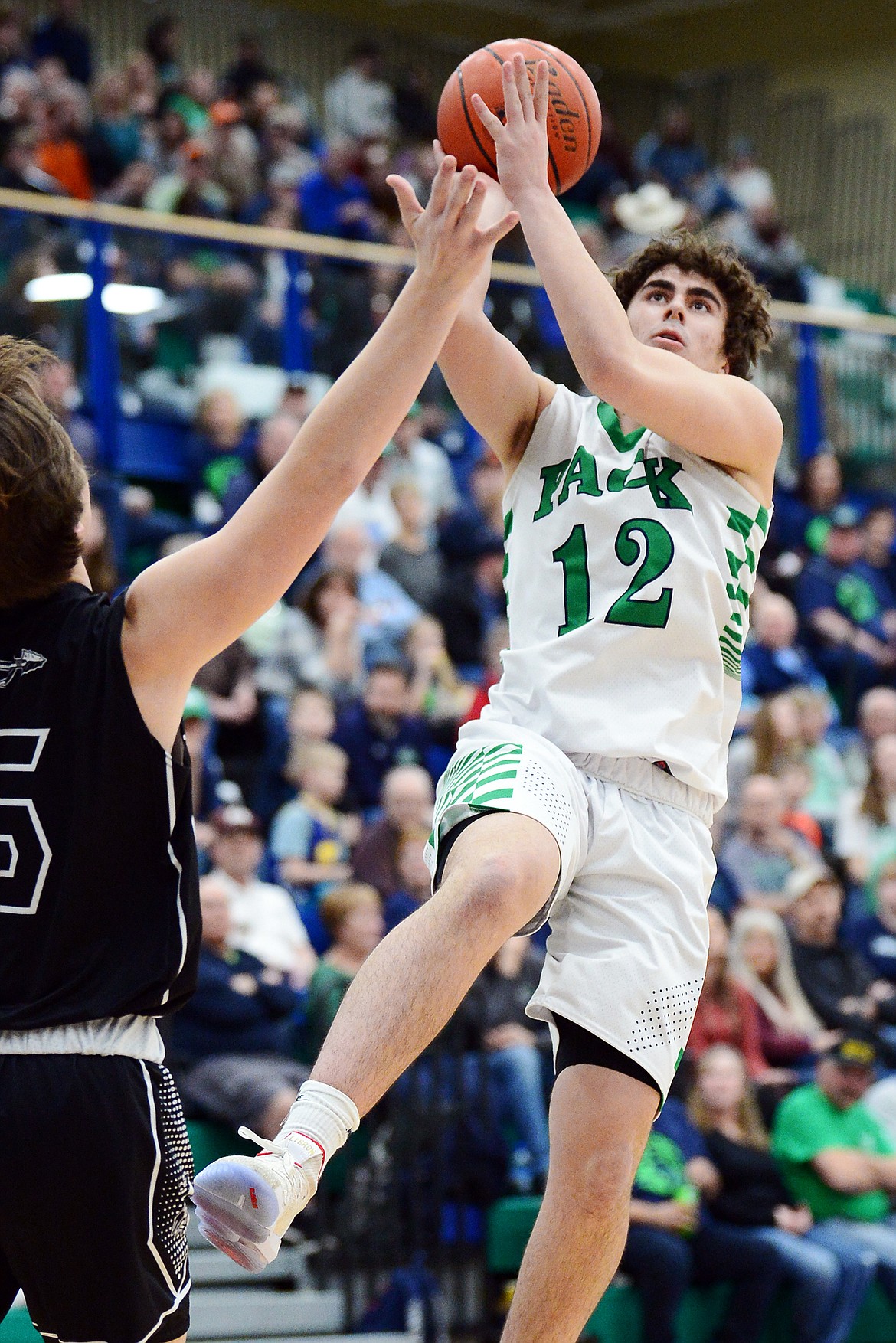 Glacier's Weston Price (12) drives to the hoop against Flathead's Tannen Beyl (5) during a crosstown matchup at Glacier High School on Friday. (Casey Kreider/Daily Inter Lake)