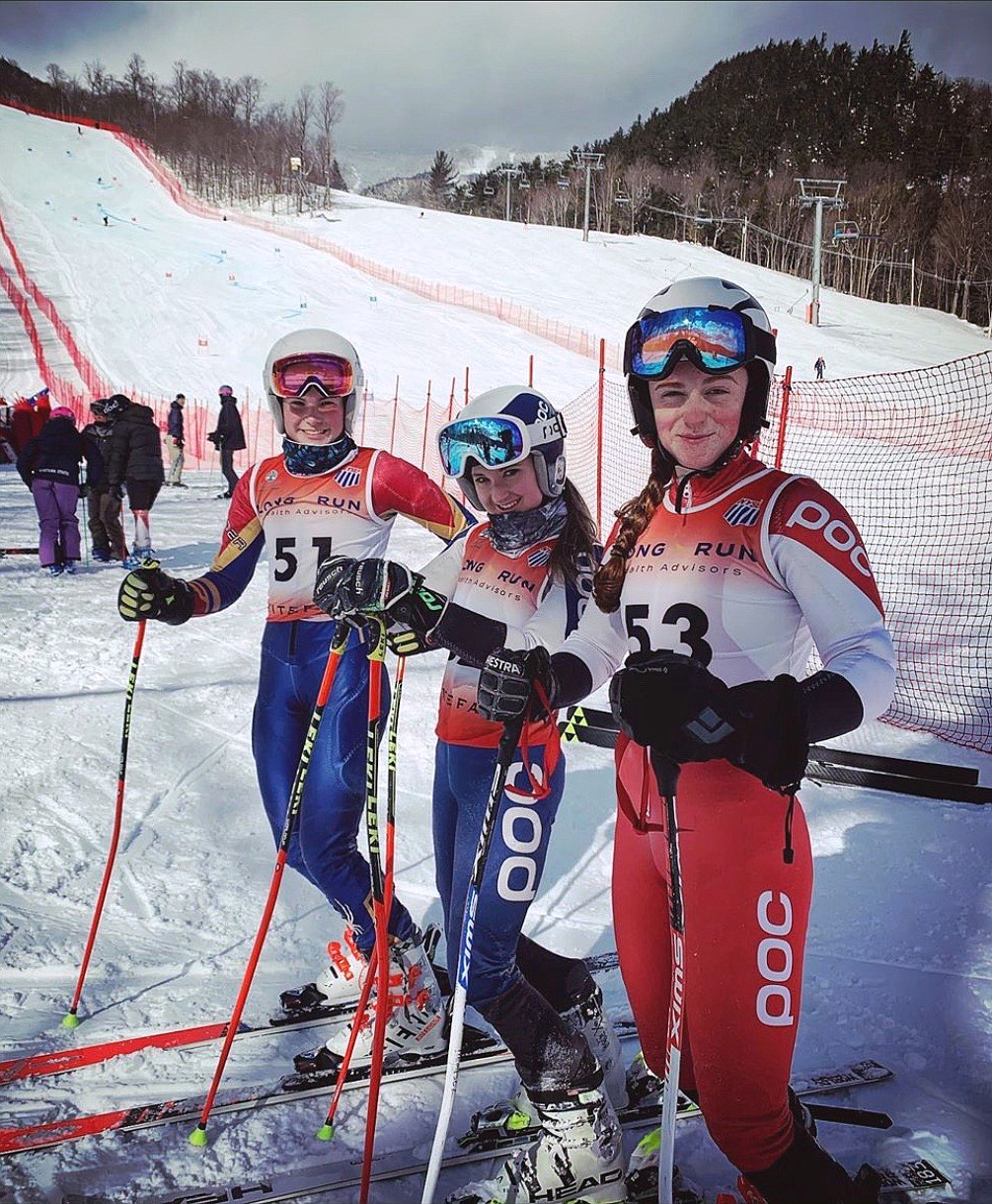 Mikaela Daniels (middle) relaxes with teammates Audrey Higgins-Lopez (left) and Norah Dempsey (right) after the great slalom race at Whiteface Mountain in New York this season. (Katie Gilligan photo)