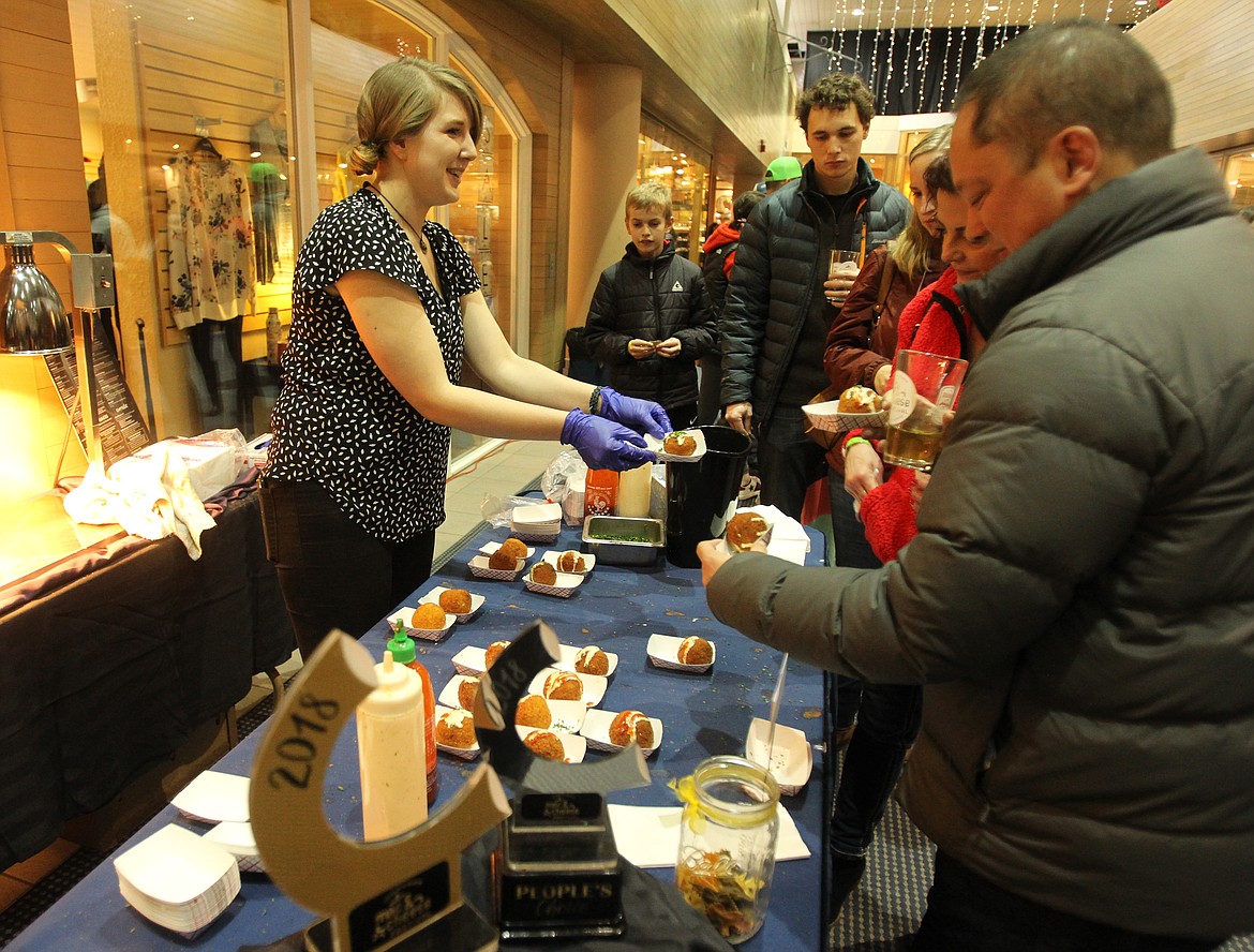 Taphouse Unchained assistant manager Sage Jensen hands out mac and cheese balls faster than you can say &quot;That's so cheesy&quot; during the second Mac and Cheese Festival on Saturday. (DEVIN WEEKS/Press)