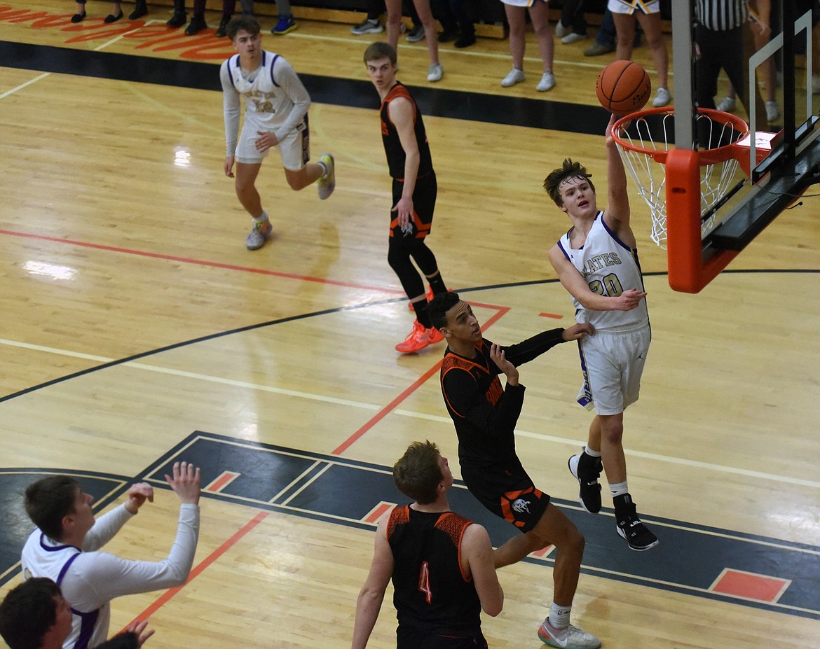 Polson guard Jarrett Wilson captializes on a fast break opportunity as the Pirates played the Frenchtown Broncs in the first round of the Western A Divisional Tournament in Ronan Feb. 27. Polson lost the game 48-39. (Whitney England/Lake County Leader)