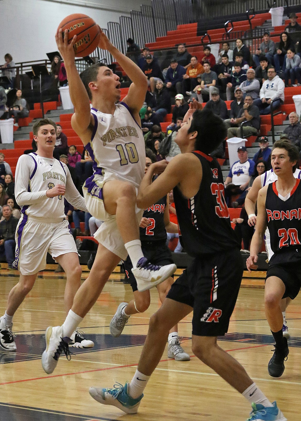 Polson Pirate Ryker Wenderoth drives hard through a Ronan defender as the Pirates eliminated Ronan Friday morning at the Western A Divisional last weekend. (Bob Gunderson photo)