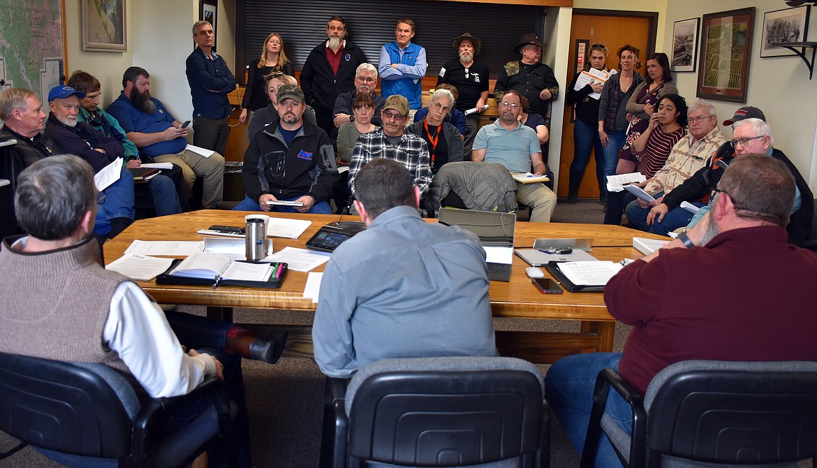 Lincoln County commissioners, from left, Jerry Bennett, Josh Letcher and Mark Peck meet with local and state officials to discuss the Montana Department of Environmental Quality’s plans for taking over the Libby Asbestos Superfund site before a packed audience March 4. (Duncan Adams/The Western News)