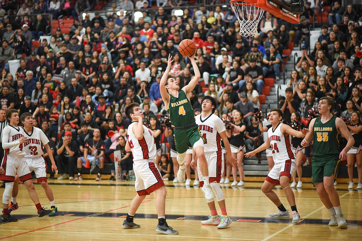 Bodie Smith skis for the layup during Friday&#146;s loss to Browning at the Western A Divisional Tournament in Ronan. (Daniel McKay/Whitefish Pilot)