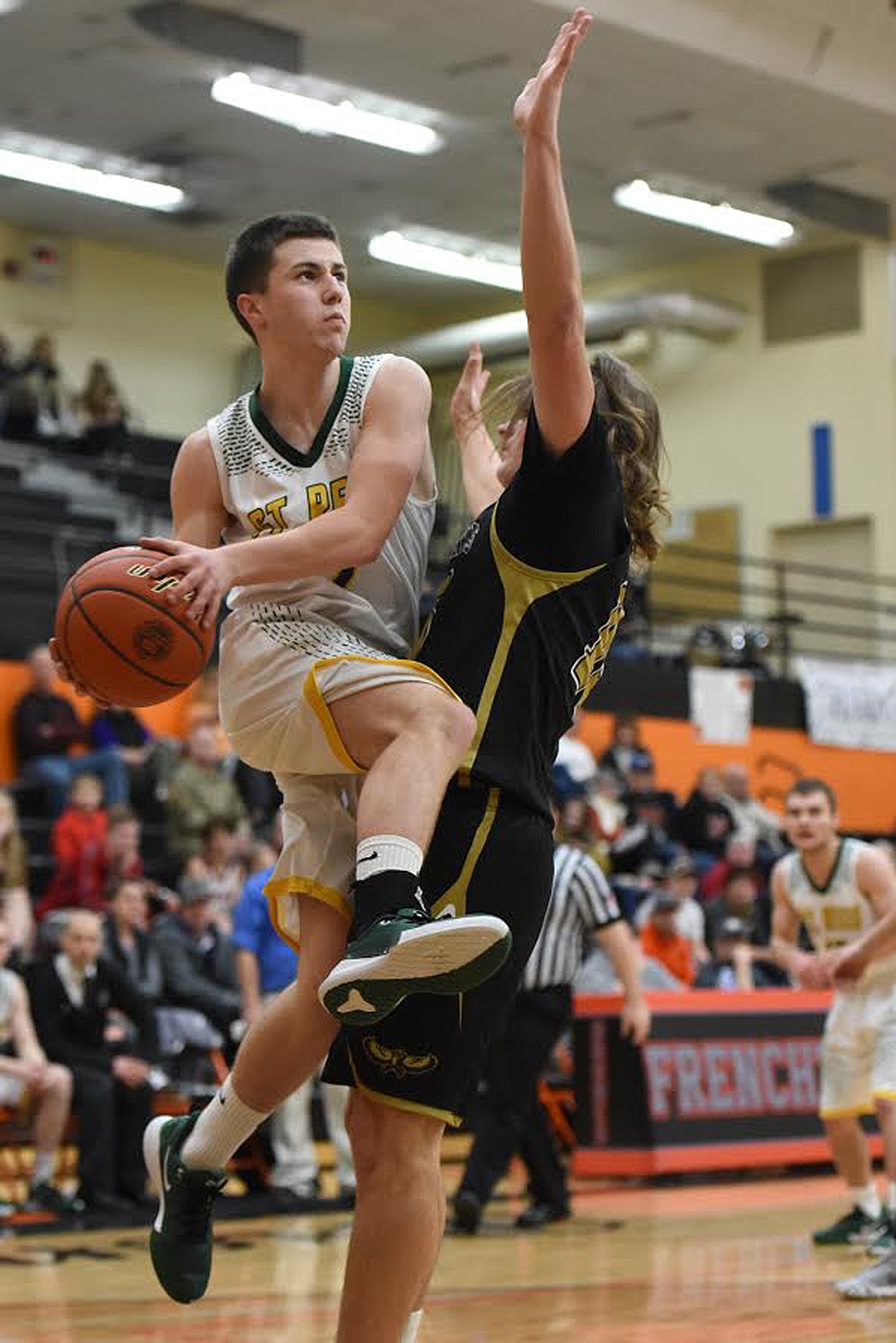 St. Regis guard Caleb Ball takes flight against Seeley-Swan defender Walker McDonald Friday at the Western C Divisional tournament in Frenchtown. (Jeremy Weber/Mineral Independent)