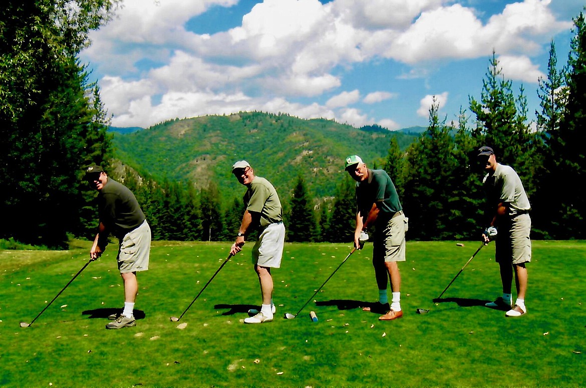 Ken Lilenkamp, Dick Lilenkamp, Sano Haldi and Kyle Haldi pose for the camera at the first tee on June 27, 2004 &#151; the 25th anniversary of the course&#146;s move to the hill.
