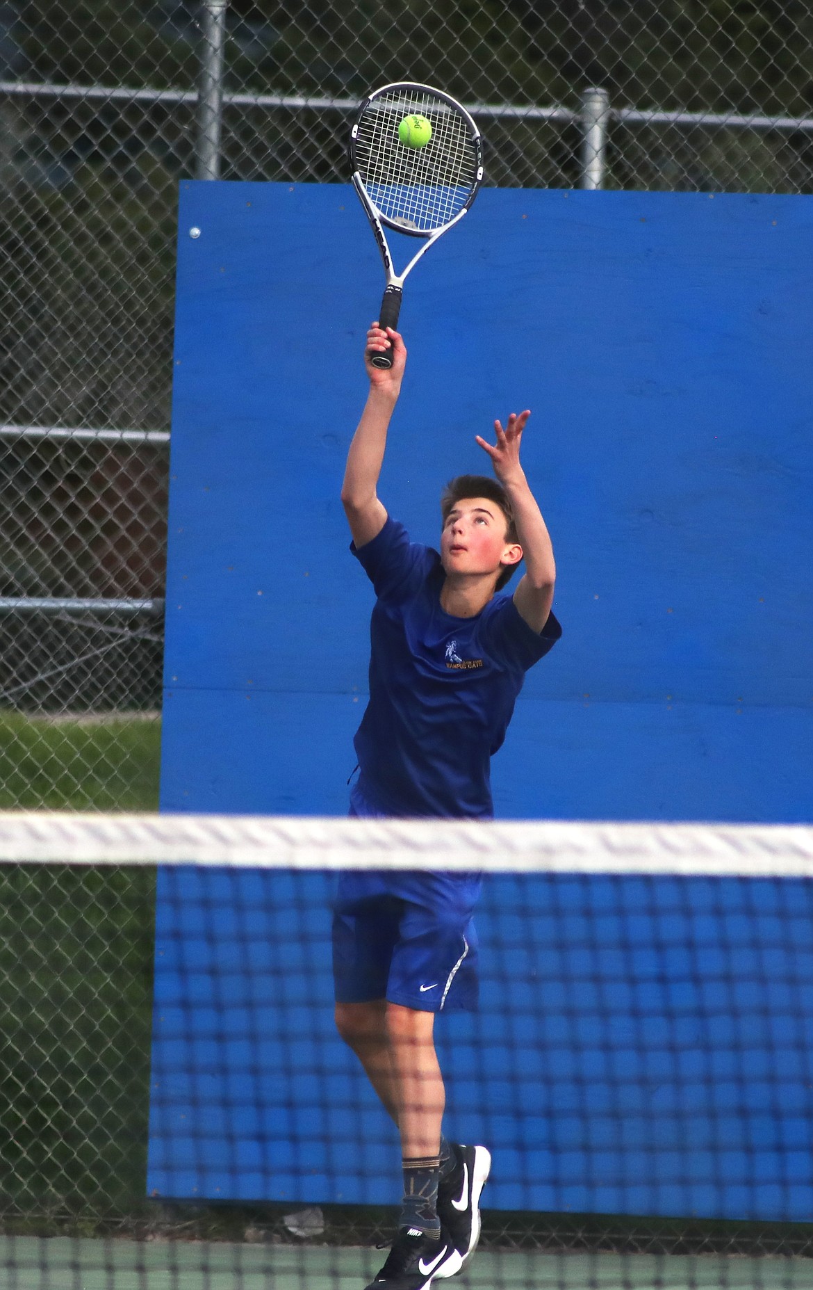 (File photo by KYLE CAJERO)
Wesley Simko serves during a boys doubles match against Coeur d'Alene on April 25.