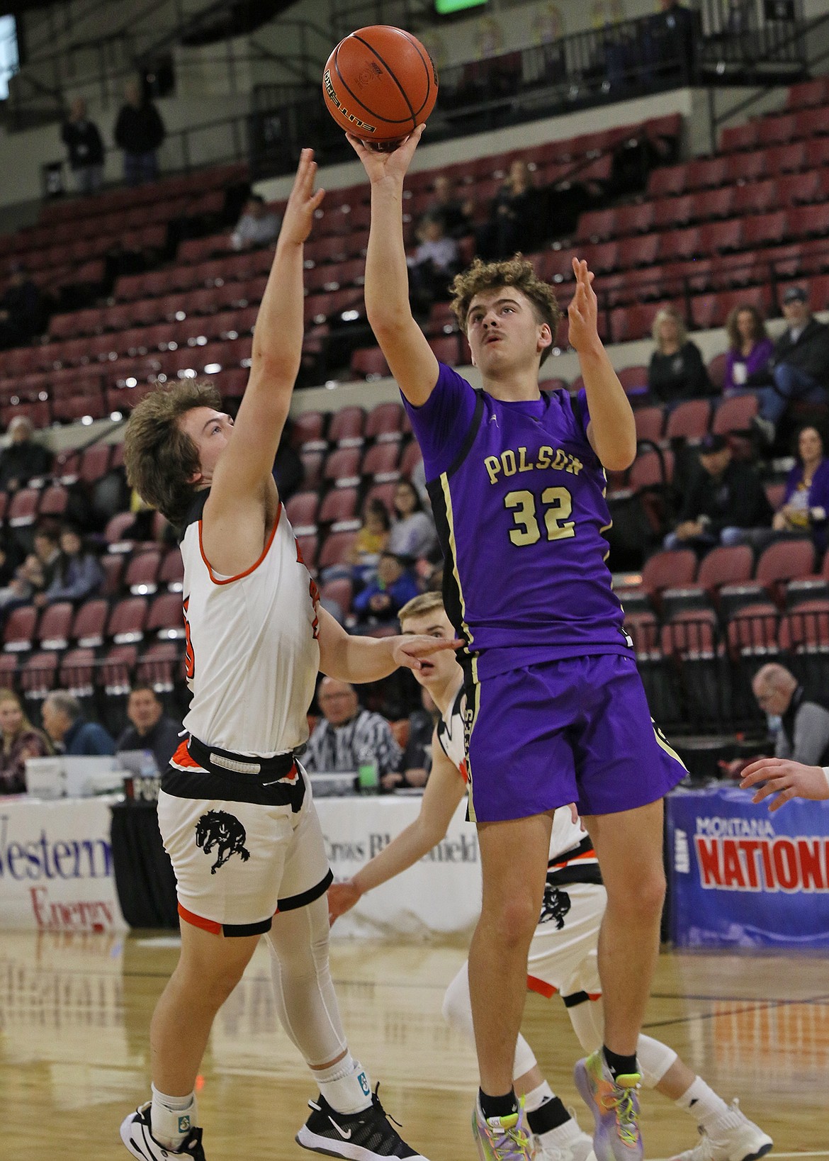 Polson's Colton Graham fires a three-pointer over Frenchtown defenders at the State A basketball tournament at Billings Skyview High School on Friday. (Bob Gunderson/Lake County Leader)