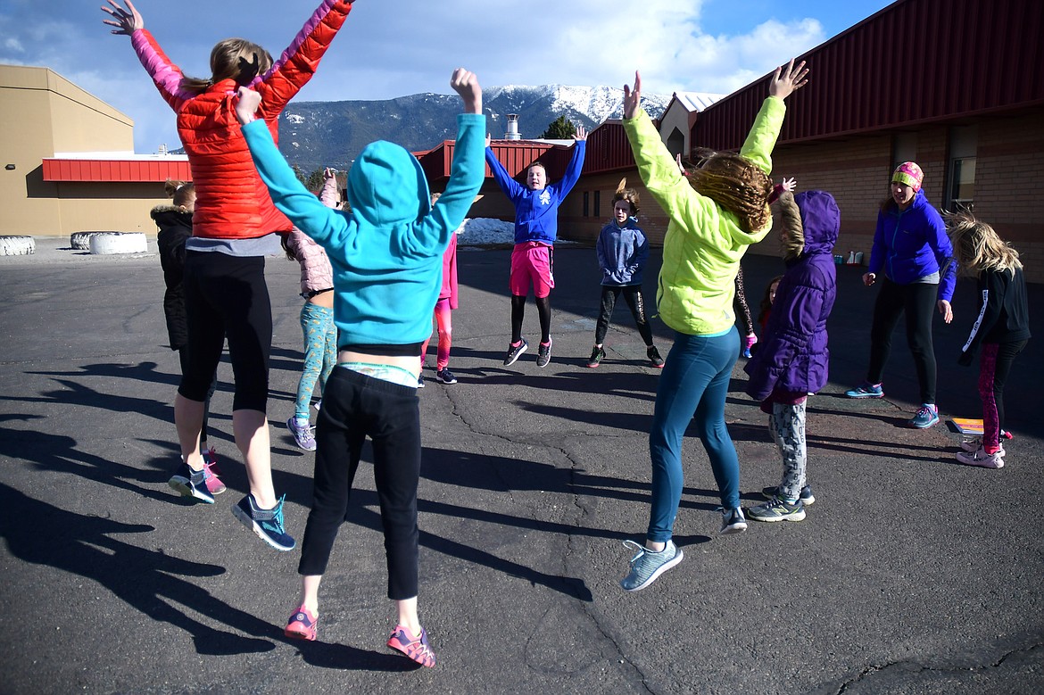 Third through fifth grade girls warm up before doing laps for Girls on the Run at Ruder Elementary last week. (Teresa Byrd/Hungry Horse News)