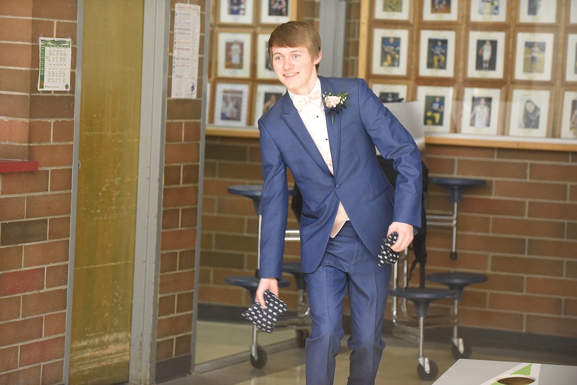 Junior Justin Morgan plays a game of corn hole at the 2020 prom last Saturday. (Scott Shindledecker/Valley Press)