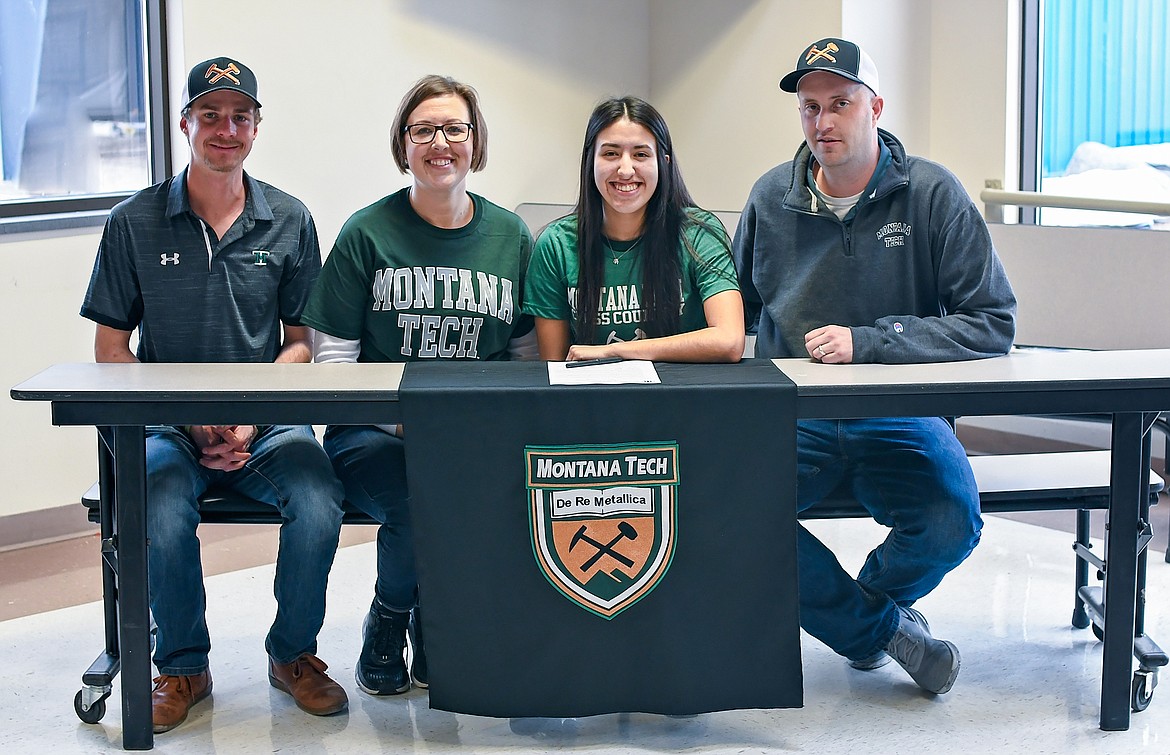 Karolyna Buck pictured with (from left to right) Montana Tech cross-country coach Zach Kughn, mother Nicky Buck and father Jeff Buck as she signs a letter of intent to run cross-country for the Orediggers next fall. (Christa Umphrey photo)