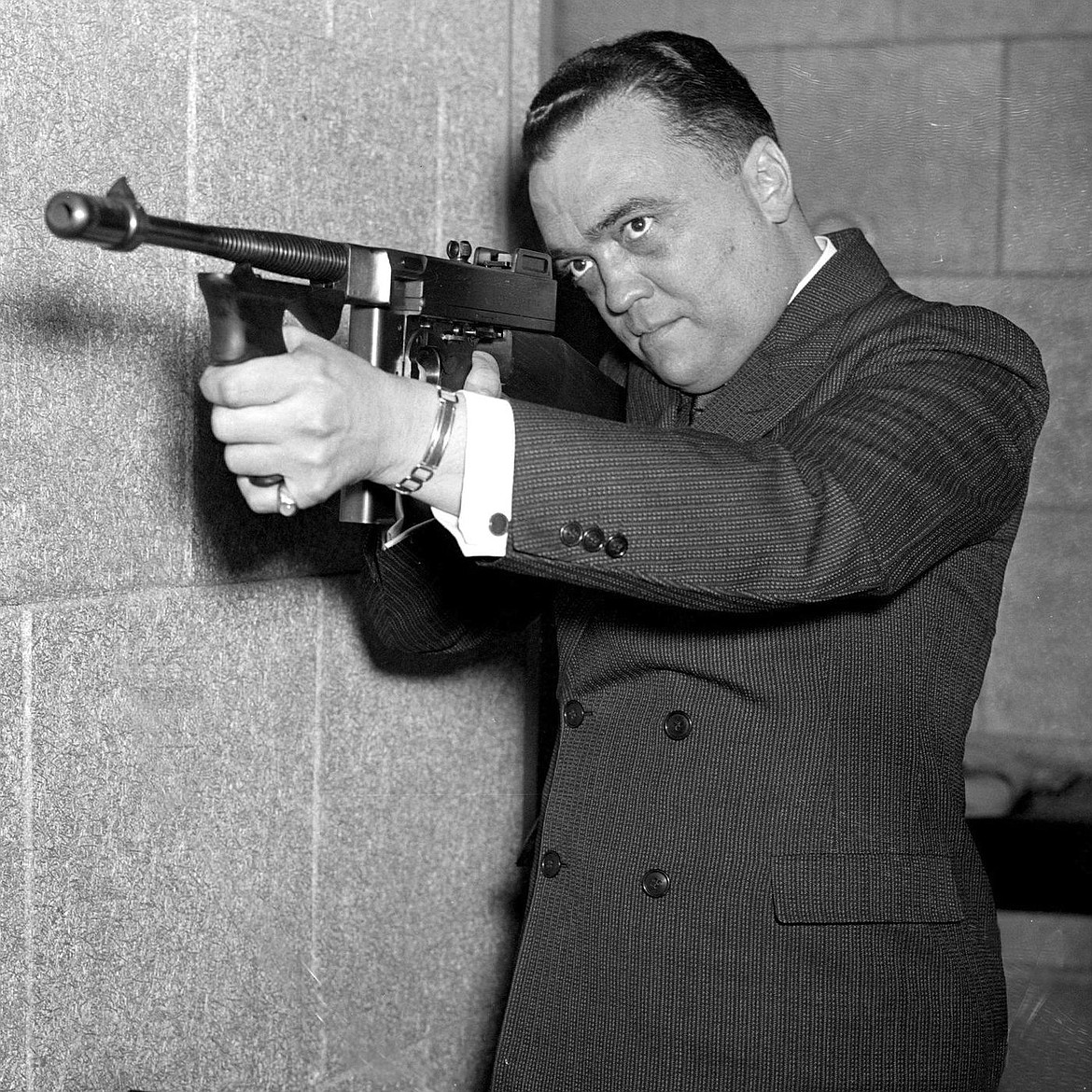 N.Y DAILY NEWS VIA GETTY IMAGES
FBI Director J. Edgar Hoover aiming popular gangster weapon Tommy gun.