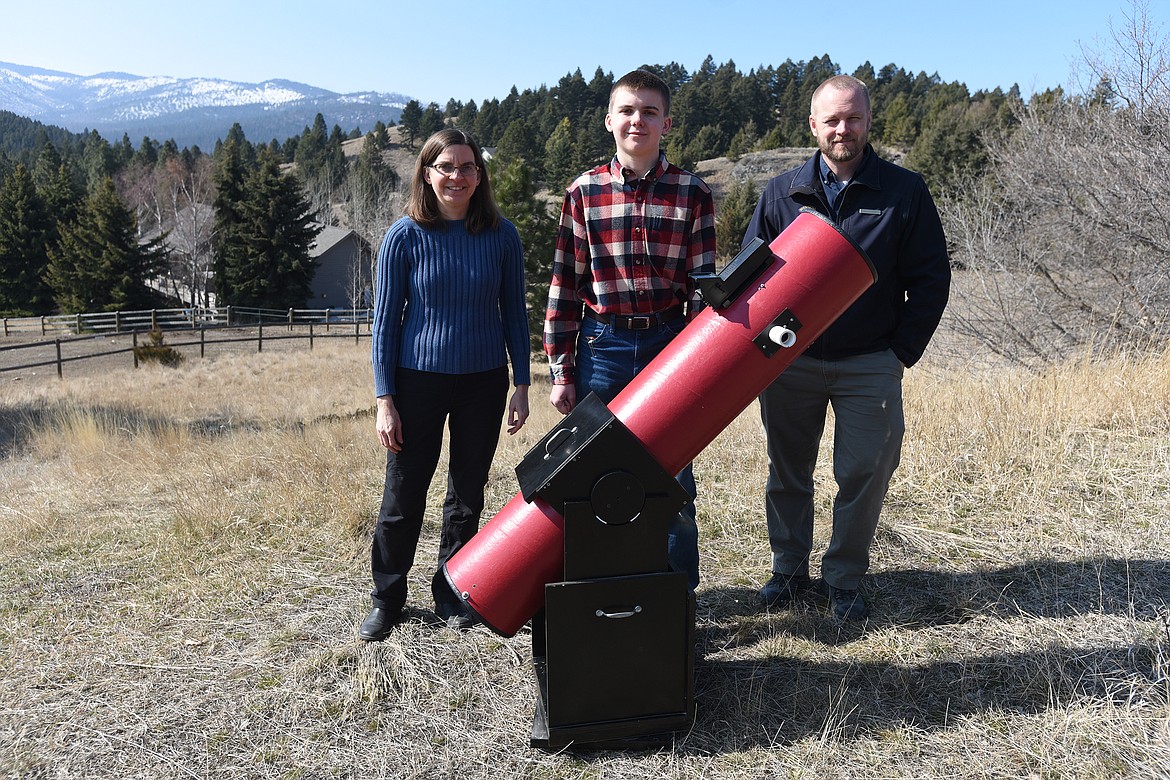 Jennifer and Andrew Hawken, along with Lone Pine State Park Manager Brian Schwartz, stand behind the 8-inch Dobsonian telescope constructed by Andrew which is used by the Flathead Valley Junior Astronomers. (Jeremy Weber/Daily Inter Lake)