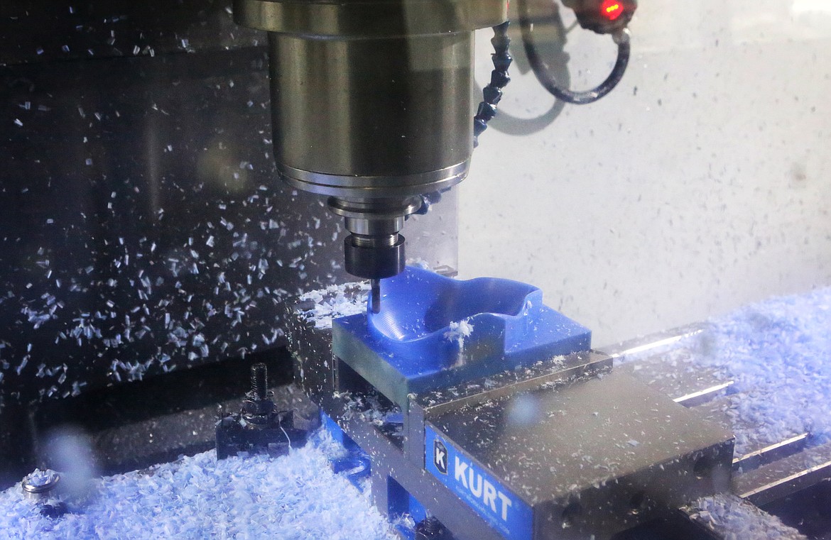 A CNC machine removes layers of Nylon 6 to create an N95 mask at Flathead Valley Community College. (Mackenzie Reiss/Daily Inter Lake)