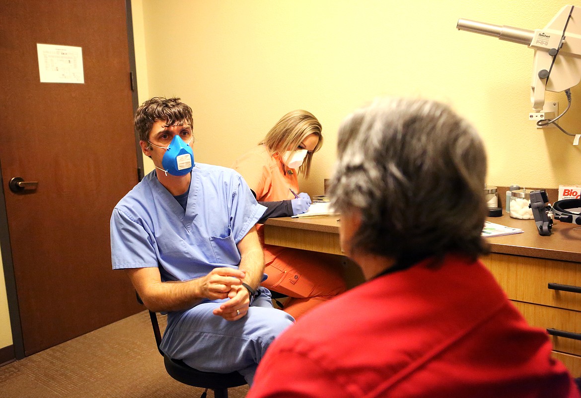 Doctor Tyler Ofstad uses an N95 mask made from a 3D printer during a visit with a patient at Glacier Eye Clinic on Thursday. (Mackenzie Reiss/Daily Inter Lake)