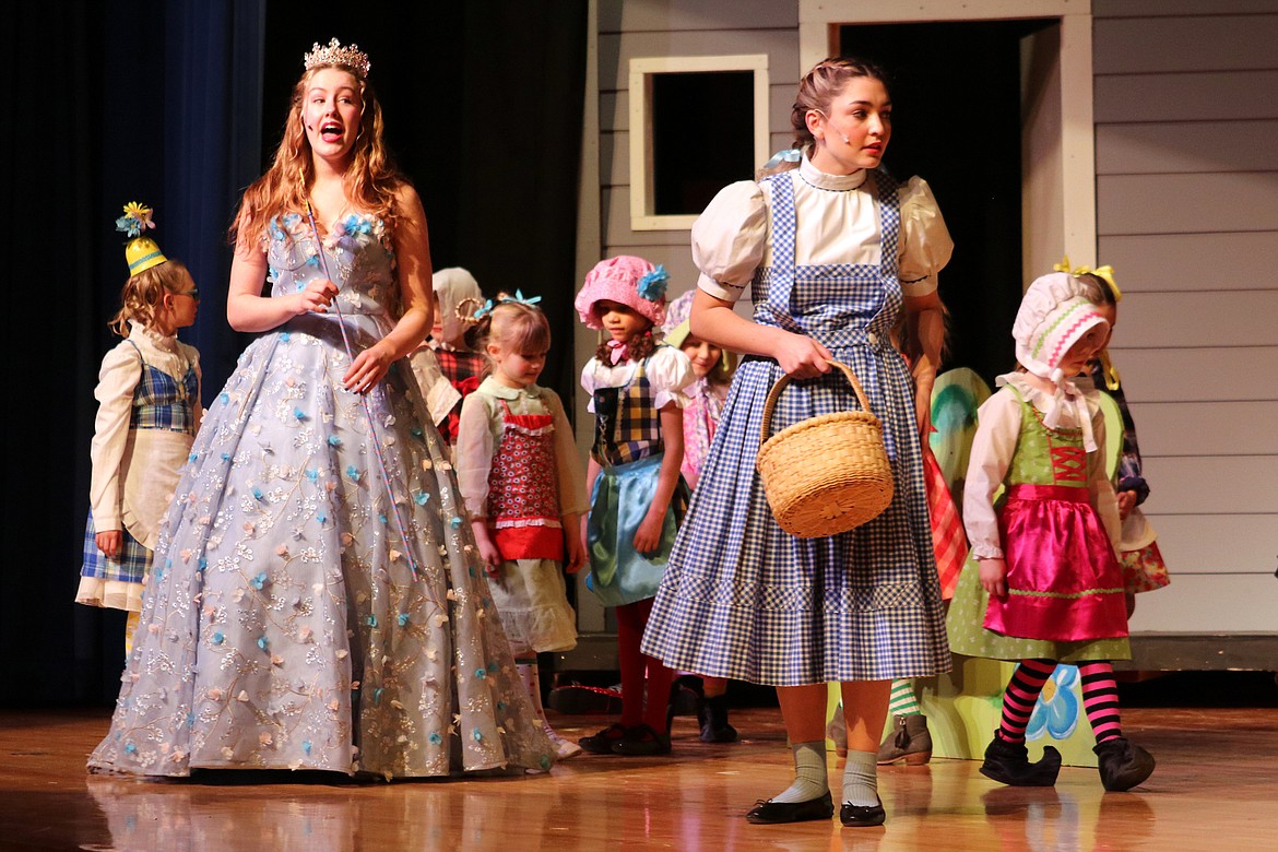 Dorothy (Noel Royer) receives instructions from Good Witch Glenda (Zerita McAtee) while surrounded by Munchkins. (Kate Daniels photo)