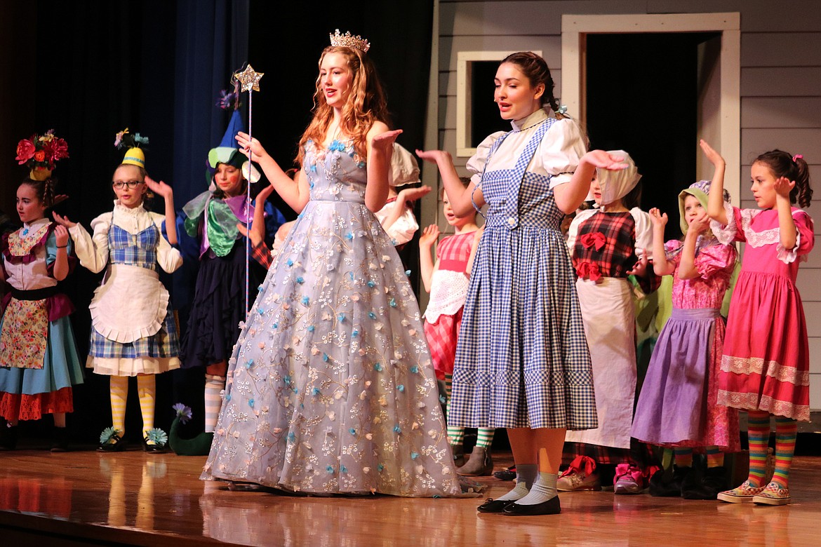 Dorothy (Noel Royer) and Good Witch Glenda (Zerita McAtee) sing along with the citizens of Munchkin Land. (Kate Daniels photo)