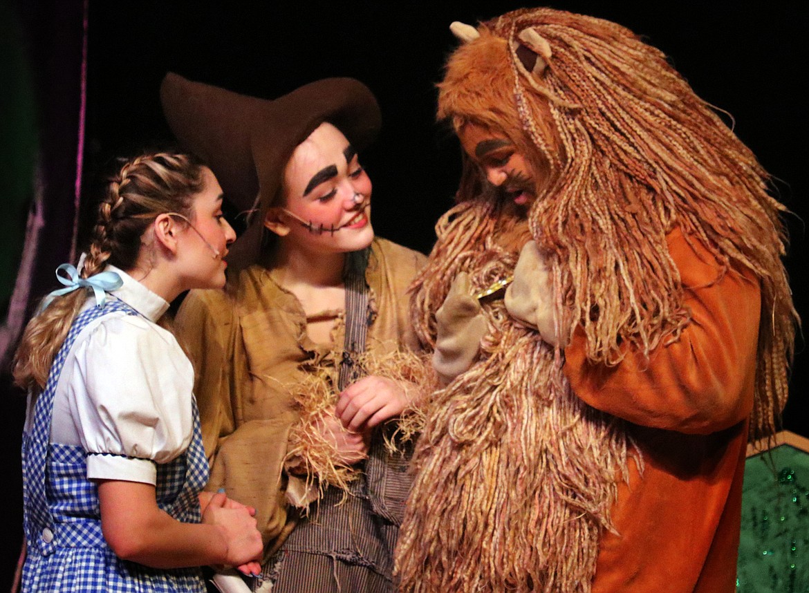 Dorothy (Noel Royer) and Scarecrow (April West) inspect the Cowardly Lion&#146;s (Jaydon Toftum) newly received medal of courage. (Kate Daniels photo)