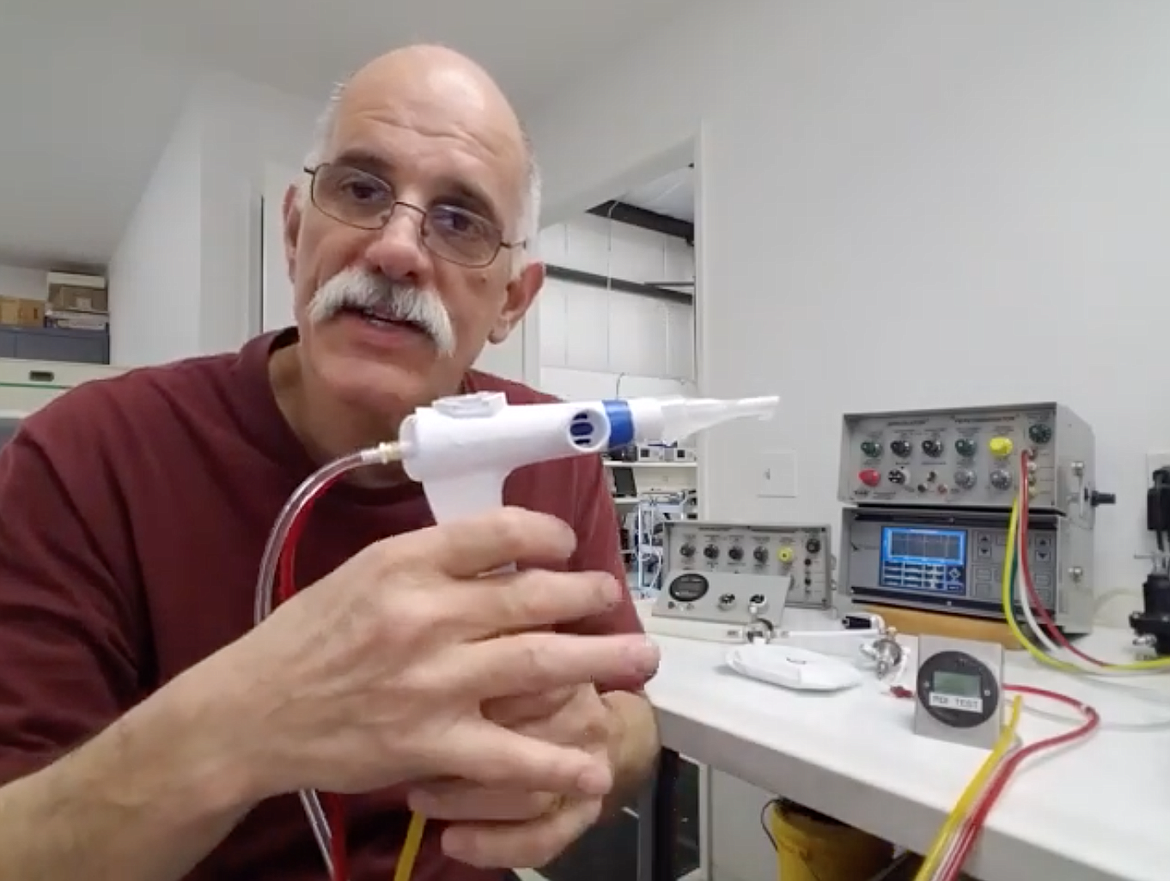 Brent Regan demonstrates his design for a compact ventilator system on a March 24 YouTube video. The design, which Regan worked in concert with Percussionaire to develop, received FDA clearance this week. (Image courtesy of YouTube)