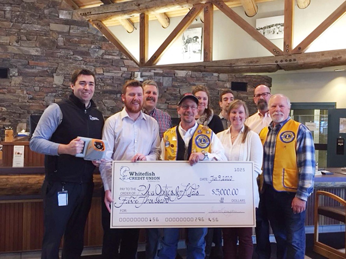 Representatives of Whitefish Credit Union present a donation to the Whitefish Lions Club for its vision screening program. (Courtesy photo)