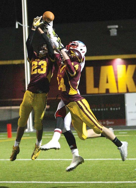 Moses Lake sophomore defensive back Ricardo Gonzalez (23) and senior defensive back Chad Palmer break up an Eastmont pass. The Chiefs won 42-34 Friday and advanced to the state tournament.