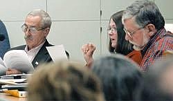Karen Nichols/Daily Inter Lake<br>Flathead County Planning Board members Russ Crowder, left, Kathy Robertson and Dan Bangeman discuss the Two Rivers master plan amendment on Dec. 15. The board voted 4-3 to approve the proposal. In 2004, the planning board had a massive workload, including a series of contentious issues.