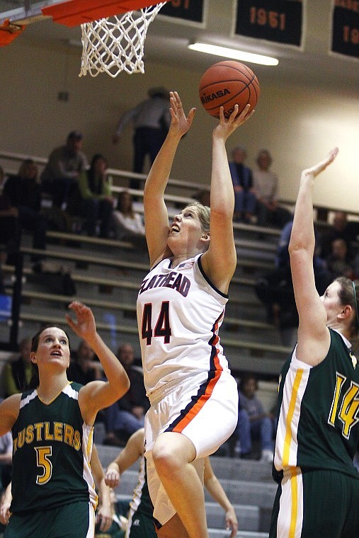 Flathead's Danika Johnson (44) goes in for a layup as CMR's Alison Sullivan (14) defends and Jordan Bagley (5) look on during Saturday afternoon's game in Kalispell.