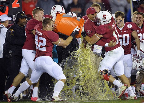 &lt;p&gt;Stanford coach David Shaw is doused by outside linebacker Alex Debniak (42) and hugged by inside linebacker Shayne Skov (11) as they celebrate their 20-14 win over Wisconsin in the Rose Bowl on Tuesday at Pasadena, Calif.&lt;/p&gt;