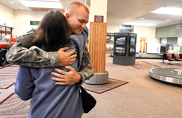 Tyler Wobschall, 17, gets a hug from his mother Tammy Wobschall at the airport on Christmas Eve. Tyler , who is stationed at Fort Hood, Texas, will be deploying to Afghanistan in March.