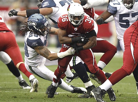 &lt;p&gt;Arizona's Ron Parker (36) gains yards as Seattle free safety Earl Thomas, left, defends during Sunday's game in Tempe, Ariz. The Cardinals won in overtime 23-20.&lt;/p&gt;