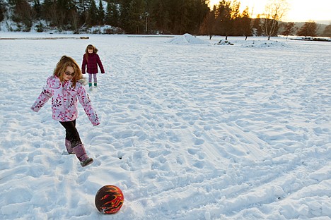 &lt;p&gt;Haven Engle, 8, kicks a ball as her friend Bella Mitchell, 9, follows along in the snow at McEuen Park Wednesday in Coeur d'Alene.&lt;/p&gt;