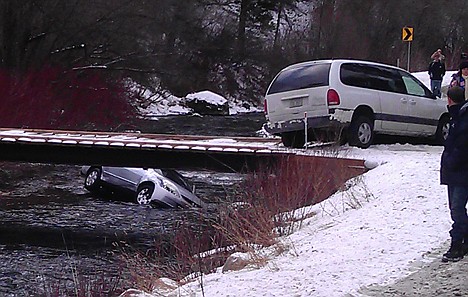 <p>A photo provided by Chris Willden shows a car in the Logan River in Utah Saturday after the car was flipped upright by rescuers who saved three children trapped in the car. The car plunged off an embankment into the river and Willden shot out the car's window with a handgun and cut a seat belt to help free the children after the accident.</p>