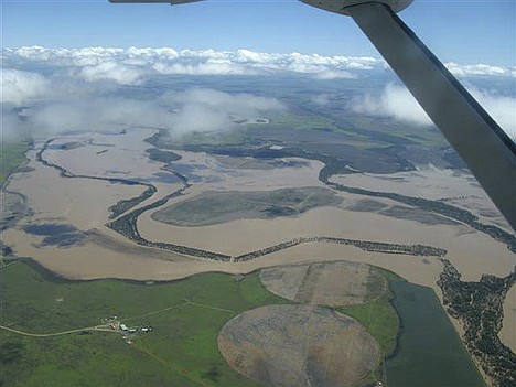 &lt;p&gt;In this aerial photo provided by the Queensland Police, a property is threatened with floodwaters near Emerald, Australia, Sunday. Floodwaters that cover an area the size of France and Germany combined are draining slowly toward Australia's northeast coast, filling bulging rivers to overflowing and inundating at least 22 towns and cities in the cattle and fruit and vegetable farming region.&lt;/p&gt;