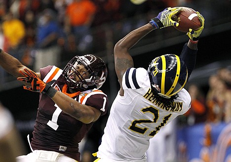 &lt;p&gt;Michigan wide receiver Junior Hemingway (21) pulls in a touchdown reception over Virginia Tech safety Antone Exum (1) during the third quarter of the Sugar Bowl NCAA college football game in New Orleans, Tuesday, Jan. 3, 2012. (AP Photo/Dave Martin)&lt;/p&gt;