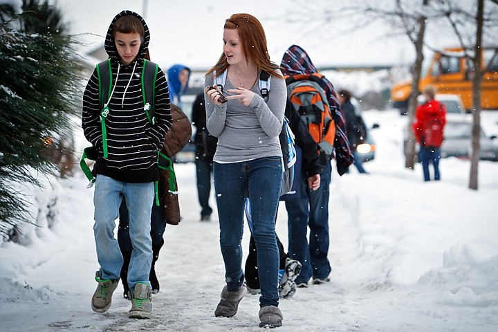 &lt;p&gt;Janelle Burnham talks to her friend Reed Woolsey, both 14, as they walk outside of Canfield Middle School after getting out of class Monday.&lt;/p&gt;