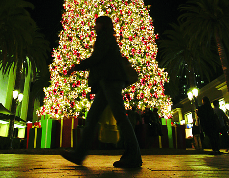 &lt;p&gt;In this Thursday, Dec. 20 photo, a holiday shopper walks past a large Christmas tree at Fashion Island shopping center in Newport Beach, Calif. A last-minute surge in spending helped many major U.S. retailers report better-than-expected sales in December, a relief for stores that make up to 40 percent of annual revenue during the holiday period.&lt;/p&gt;