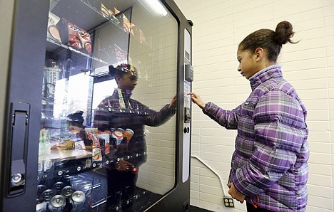 &lt;p&gt;A 12-year-old girl, who declined to be identified, makes a purchase at a vending machine in Seattle on Dec. 23, 2013.&lt;/p&gt;