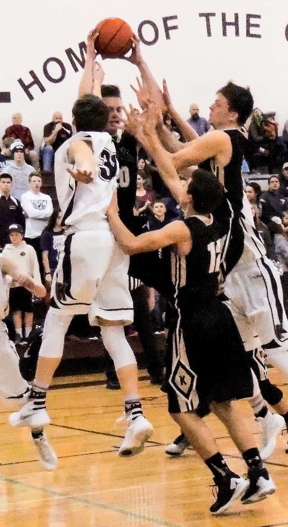 Corbin Christensen, Carson Gilbert and Sam Christensen battle Brock Ravet and an unidentifiable Coyote for an early rebound.