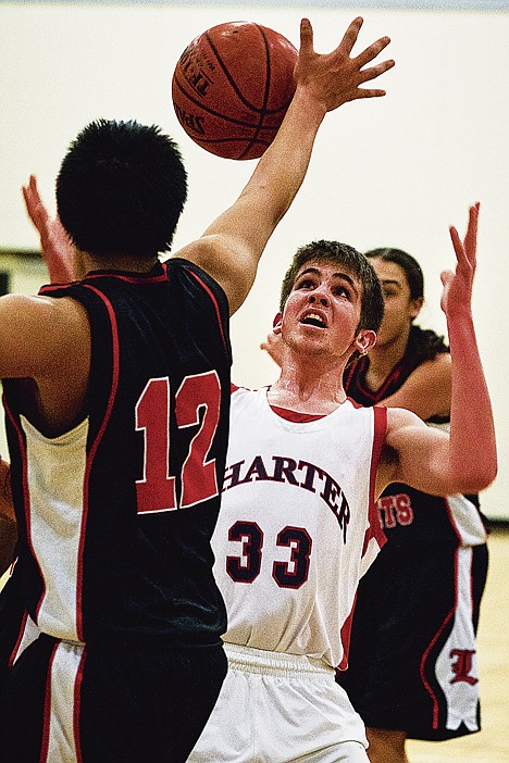 &lt;p&gt;Bryan Smith, guard for Coeur d'Alene Charter Academy, gets position over a Lakeside defender for a rebound in the first half.&lt;/p&gt;