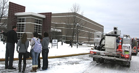 &lt;p&gt;Post Falls Police Capt. Greg McLean instructs Post Falls High students into the building after it was deemed safe following a dryer fire that caused smoke throughout the building and cancelled classes on Tuesday morning. Students were sent to nearby Prairie View Elementary and Real Life Ministries to warm up during the freezing temperatures until buses or other connections arrived.&lt;/p&gt;