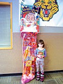 Tiana Goatley stands next to the giant stocking she won for displaying acts of good behavoir and kindness.