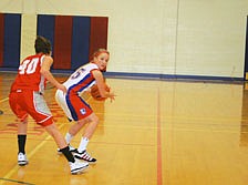 Nicole Stroot guards the ball from a defender on the other team.