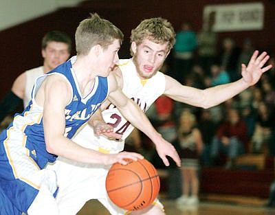 <p>Junior Mason Chapel guarding Tanner Laws in second quarter vs. Thompson Falls Jan. 2, 2016.</p>