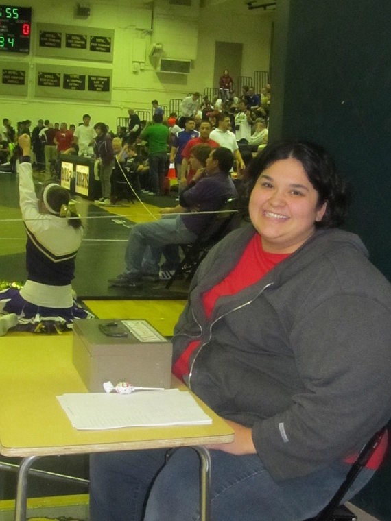 Josie Cera, who works in special education at Royal High School,
charges admission and guards the entrance against free-loaders at
the Royal Christmas Wrestling Tournament last Thursday, but she
does it with a smile.