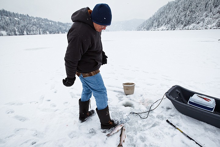 &lt;p&gt;Tom Colnaric measures his catch against the size of his boot while fishing on Fernan Lake earlier this week.&lt;/p&gt;