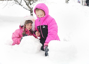 <p>Brooklyn, left, and Lucy Ek help each other make a snowman in Somers on Tuesday. Snow depths of nearly 2 feet from a storm Sunday and Monday allowed for plenty of winter fun. </p>